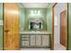 Quaint bathroom features vintage mirror, vanity, and cabinets, complemented by green walls at 4065 E University -- # 433, Mesa, AZ 85202