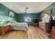 Cozy bedroom featuring wood-look floors, accent wall, and ample closet space at 4065 E University -- # 433, Mesa, AZ 85202