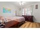 Bedroom with a four-post bed, ceiling fan, and wood-look floors at 4065 E University -- # 433, Mesa, AZ 85202