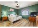 Cozy bedroom featuring wood-look floors, accent wall, and ample closet space at 4065 E University -- # 433, Mesa, AZ 85202