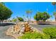 Inviting community entrance with lush landscaping, rock waterfall, and Citrus Gardens signage at 4065 E University -- # 433, Mesa, AZ 85202