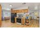 Open concept kitchen with wood cabinets and a range at 4065 E University -- # 433, Mesa, AZ 85202