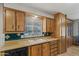 Charming kitchen features classic wood cabinets, blue tile backsplash, and a bright window view at 4065 E University -- # 433, Mesa, AZ 85202