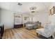 Living room featuring gray sofa, wood-look floors, and natural light at 4065 E University -- # 433, Mesa, AZ 85202