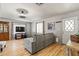 Living room with modern gray sofa, wood-look floors, and natural light at 4065 E University -- # 433, Mesa, AZ 85202