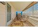 Covered patio with patterned outdoor rug, furniture, lattice shade and door to home at 4065 E University -- # 433, Mesa, AZ 85202