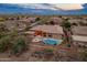 Aerial view of the property featuring a pool, patio, and lush backyard in a desert community at 42101 N Olympic Fields Ct, Anthem, AZ 85086