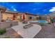 Expansive backyard with a built-in BBQ, covered patio, spa, pool, desert landscaping and beautiful mountain view at 42101 N Olympic Fields Ct, Anthem, AZ 85086