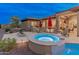 Beautiful backyard with a relaxing spa, built in BBQ, and a cozy fire pit at 42101 N Olympic Fields Ct, Anthem, AZ 85086