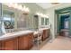Bathroom with double sinks, bright lighting, glass block and bathtub at 42101 N Olympic Fields Ct, Anthem, AZ 85086