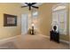 Bedroom with a ceiling fan, large window and neutral paint colors at 42101 N Olympic Fields Ct, Anthem, AZ 85086