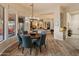Elegant dining area with a stylish chandelier and comfortable seating, set within a bright, open layout at 42101 N Olympic Fields Ct, Anthem, AZ 85086