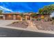 A grand home with illuminated front steps, three-car garage, and desert landscaping at 42101 N Olympic Fields Ct, Anthem, AZ 85086