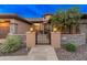 Stunning front entrance with stone accents, landscaped yard, and wrought iron gate at 42101 N Olympic Fields Ct, Anthem, AZ 85086