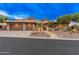 Impressive home exterior featuring a three-car garage, desert landscaping, and mountain views at 42101 N Olympic Fields Ct, Anthem, AZ 85086