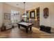 The game room features a pool table, built-in bar, and a comfortable chair at 42101 N Olympic Fields Ct, Anthem, AZ 85086