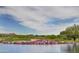 Beautiful golf course with colorful flowers and a scenic lake in a desert landscape at 42101 N Olympic Fields Ct, Anthem, AZ 85086