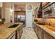 Modern kitchen showcasing stainless steel appliances, custom cabinetry, and an island sink with granite counters at 42101 N Olympic Fields Ct, Anthem, AZ 85086