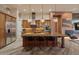 Well-equipped kitchen featuring wood cabinets, a large island with seating, and stainless steel appliances at 42101 N Olympic Fields Ct, Anthem, AZ 85086