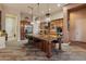 Spacious kitchen with a large center island, wood cabinetry, and modern stainless steel appliances at 42101 N Olympic Fields Ct, Anthem, AZ 85086