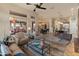 Expansive living room featuring neutral tones, wood floors, and seamless indoor/outdoor living at 42101 N Olympic Fields Ct, Anthem, AZ 85086