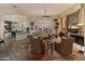 Inviting living room with stone fireplace, comfortable seating, and open floor plan to kitchen at 42101 N Olympic Fields Ct, Anthem, AZ 85086