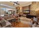 Comfortable living room with large windows, cozy seating, and stylish decor elements at 42101 N Olympic Fields Ct, Anthem, AZ 85086