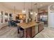 Open floor plan with a kitchen island, dining area, and views into the living room and beyond at 42101 N Olympic Fields Ct, Anthem, AZ 85086