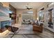 Well-lit living room with contemporary fireplace, and stylish, comfortable furniture arrangements at 42101 N Olympic Fields Ct, Anthem, AZ 85086