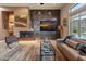 Modern living room with sleek fireplace, contemporary furnishings, and natural light at 42101 N Olympic Fields Ct, Anthem, AZ 85086