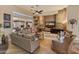 The living room has a stone accent wall, ceiling fan, and large windows at 42101 N Olympic Fields Ct, Anthem, AZ 85086