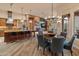 Bright, open-concept living space with a spacious kitchen island, dining area, and modern decor at 42101 N Olympic Fields Ct, Anthem, AZ 85086
