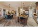 Bright open-concept living space featuring a kitchen island, dining area, and seamless transition to other rooms at 42101 N Olympic Fields Ct, Anthem, AZ 85086