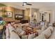 Bright living room featuring a decorative stone wall, comfortable seating, and neutral decor at 42101 N Olympic Fields Ct, Anthem, AZ 85086