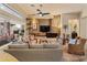 The living room has a stone accent wall, ceiling fan, and large windows at 42101 N Olympic Fields Ct, Anthem, AZ 85086