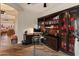 Home office boasts custom built-in shelving and a desk setup, complete with exercise equipment at 42101 N Olympic Fields Ct, Anthem, AZ 85086