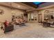 An inviting covered patio offers comfortable seating, ceiling fans, and seamless access to indoor/outdoor living at 42101 N Olympic Fields Ct, Anthem, AZ 85086