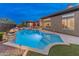 Home has a beautiful pool with integrated spa, a built-in fire pit, and low maintenance landscaping at 42101 N Olympic Fields Ct, Anthem, AZ 85086