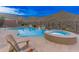 A gorgeous pool and spa are surrounded by desert landscaping and have mountain views at 42101 N Olympic Fields Ct, Anthem, AZ 85086