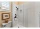 Walk-in shower featuring stylish white tile design with a modern shower head and niche at 42101 N Olympic Fields Ct, Anthem, AZ 85086