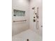 Elegant tile shower with bronze fixtures and inset shelf at 42101 N Olympic Fields Ct, Anthem, AZ 85086