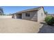 Exterior view of the home showcasing the gravel backyard with a privacy wall at 43205 W Oster Dr, Maricopa, AZ 85138