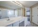 Large bathroom features double sinks, tile flooring, and a vanity area with a view of the bedroom at 43205 W Oster Dr, Maricopa, AZ 85138