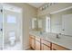 This bathroom features a double sink vanity, an attached toilet room and bright vanity lighting at 43205 W Oster Dr, Maricopa, AZ 85138