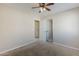 This bedroom offers neutral tones, soft carpet and a view into the hallway and closet at 43205 W Oster Dr, Maricopa, AZ 85138