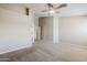 Expansive bedroom with neutral carpet and walls, featuring high ceilings and bright doorways at 43205 W Oster Dr, Maricopa, AZ 85138