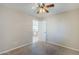 This bedroom boasts neutral tones, ceiling fan, and view into an additional room through the doorway at 43205 W Oster Dr, Maricopa, AZ 85138