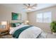 A virtually staged room featuring a bed, side tables, lamps, decorative pillows and decor at 43205 W Oster Dr, Maricopa, AZ 85138