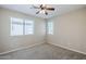 This bedroom offers a cozy space with a ceiling fan and two windows offering lots of natural light at 43205 W Oster Dr, Maricopa, AZ 85138