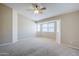 A spacious bedroom with neutral walls and carpet, complemented by bright natural lighting at 43205 W Oster Dr, Maricopa, AZ 85138